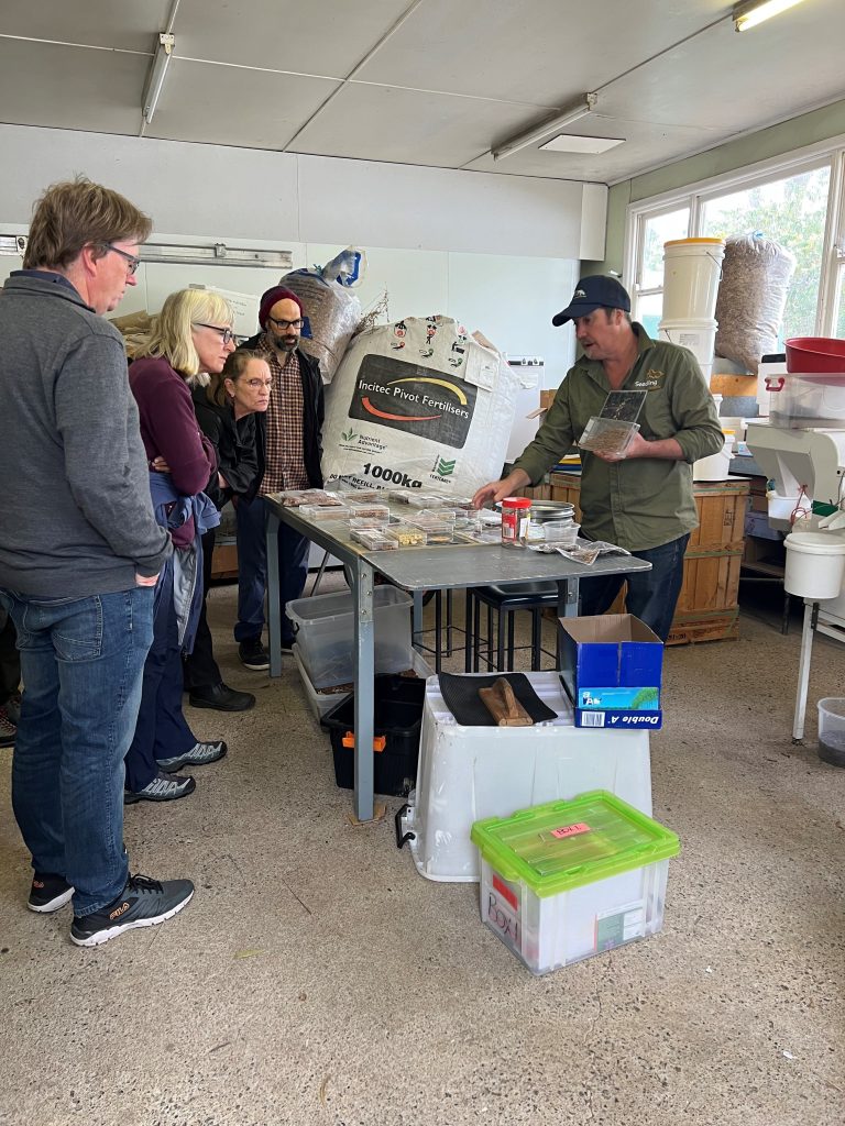 Group learning about fertilizer processes indoors.